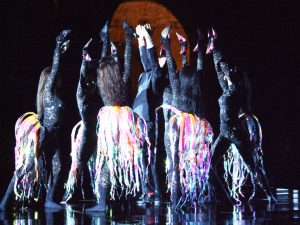 Crowd of Dancers in Black with Ribbon Tails